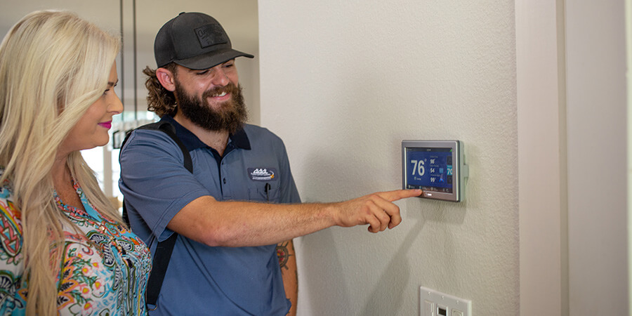 Pinellas Comfort System's technician showing homeowner improved air conditioning